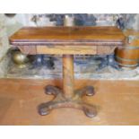 A REGENCY ROSEWOOD FOLD OVER CARD TABLE With green baize playing surface, raised on a tapering