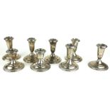 FOUR PAIRS OF VINTAGE STERLING SILVER SQUAT CANDLESTICKS Two with gadrooned decoration to outer