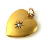 A 19TH CENTURY YELLOW METAL AND SEED PEARL HEART FORM PENDANT With single seed pearl and monogram to