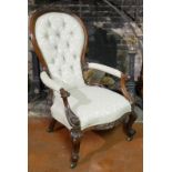 A HIGH VICTORIAN MAHOGANY SPOONBACK OPEN ARMCHAIR Carved with florets, scroll arms, on cabriole
