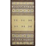 AN INDO-TURKISH KILIM GRUBY WOOLLEN RUG With bands of geometric designs on mustard yellow and