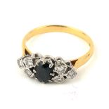 A VINTAGE 18CT GOLD, DIAMOND AND SAPPHIRE RING The oval cut sapphire flanked by round cut