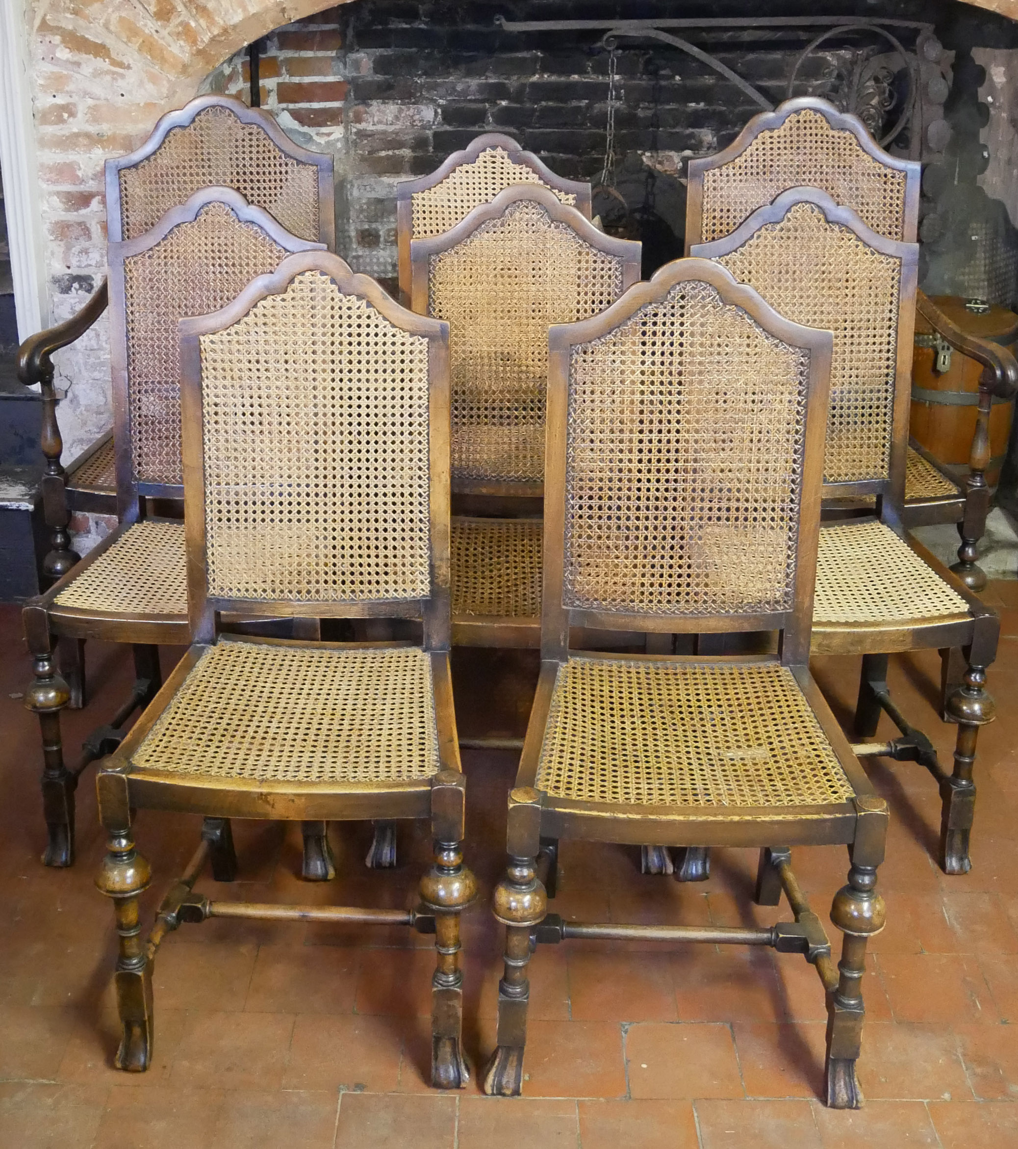 A SET OF SIX INCLUDING TWO CARVERS QUEEN ANNE DESIGN WALNUT DINING CHAIRS With cane seats and backs.
