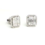 A PAIR OF 18CT WHITE GOLD AND BAGUETTE CUT DIAMOND EARRINGS The baguette cut stones edged with round