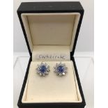 A PAIR OF CORNFLOWER BLUE BRILLIANT CUT DIAMOND CLUSTER STUDS. (diamond approx 1.42ct, colour G/H)