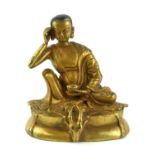 A CHINESE GILT BRONZE BODHISATTVA BUDDHA In a pensive seated pose with one arm raised and a