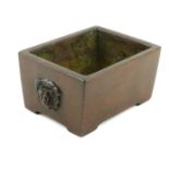 A CHINESE BRONZE CENSER Heavy gauge rectangular form, with twin mask mounts and square Chinese