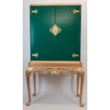 A 1920'S QUEEN ANNE DESIGN PAINTED AND GILTWOOD COCKTAIL CABINET ON STAND Gilt metal mounted,