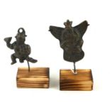 TWO CHINESE BRONZE MINIATURE FIGURAL PLAQUES Winged mythical beast and an acrobat, on wood bases. (