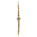 A 9CT GOLD LADIES' WRISTWATCH Champagne tone dial and quartz movement, marked 'BB' with crown to