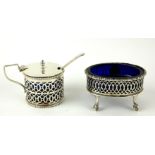 AN EARLY 20TH CENTURY SILVER AND BLUE GLASS MUSTARD POT, having pierced decoration, hallmarked