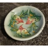 MOORCROFT, A VINTAGE TUBE LINED POTTERY PLATE Floral decoration, pressed marks to base and