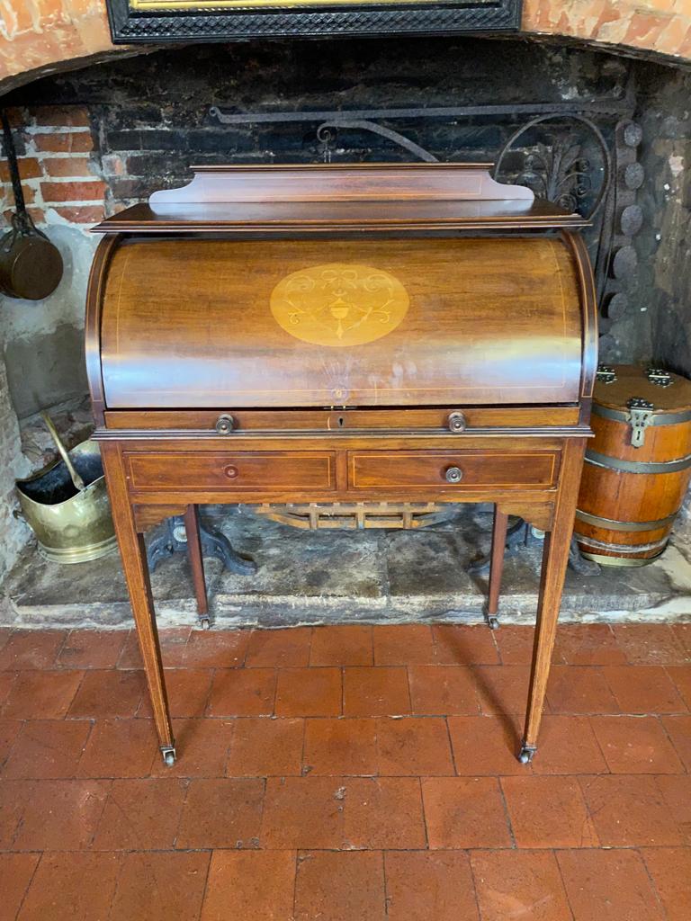 AN EDWARDIAN MAHOGANY AND MARQUETRY INLAID CYLINDER WRITING BUREAU Having a fitted interior above