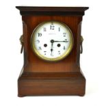 MAPLE AND CO., A LATE 19TH/EARLY 20TH CENTURY MANTLE CLOCK Architectural form with twin brass mask