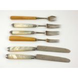 A COLLECTION OF GEORGIAN SILVER AND MOTHER OF PEARL CUTLERY Two fruit knives and forks, with