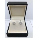 A PAIR OF 18CT WHITE GOLD AND DIAMOND CLUSTER EARRINGS. (diamond approx 0.48ct)