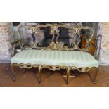 AN 18TH CENTURY ITALIAN WALNUT AND PARCEL GILT OPEN ARM CHAIR SETTEE With pierced strap work back