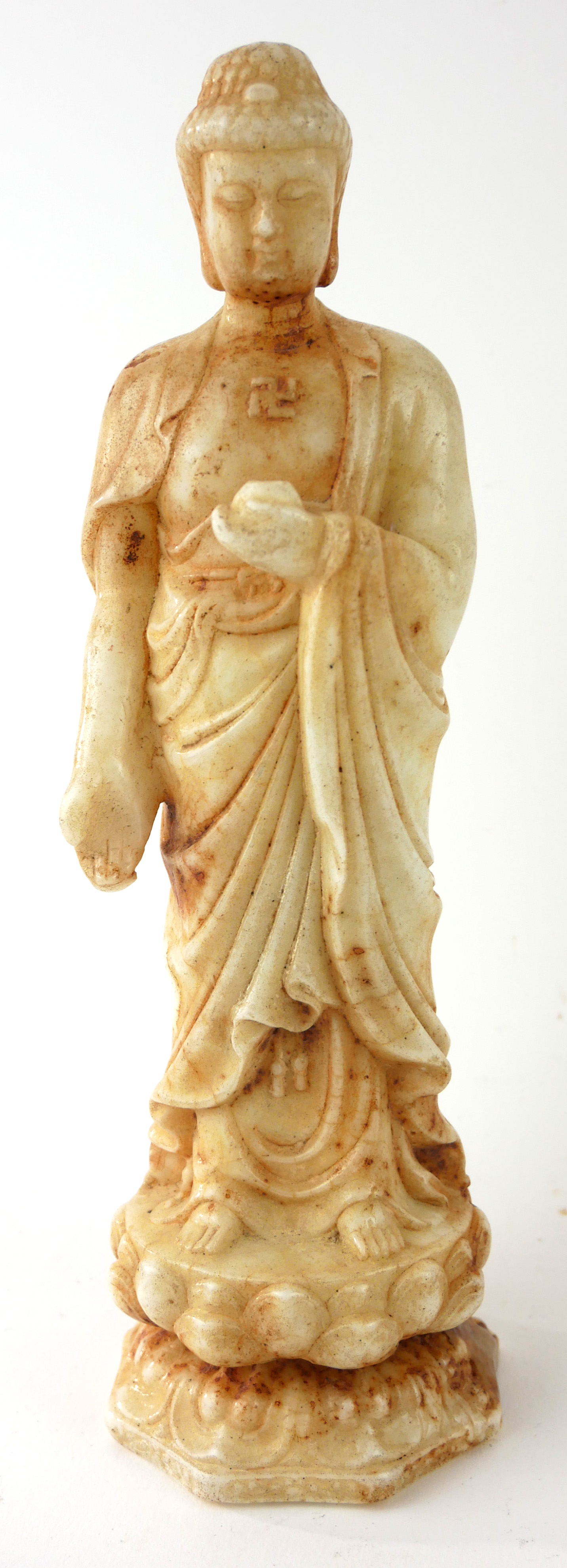 A CHINESE WHITE RUSSET JADE BUDDHA STATUE Standing pose on double lotus base. (approx 23cm)