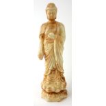 A CHINESE WHITE RUSSET JADE BUDDHA STATUE Standing pose on double lotus base. (approx 23cm)