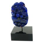 A CHINESE CARVED LAPIS LAZULI KYLIN SCULPTURE, A MYTHICAL BEAST With spherical objects, on a black