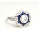 AN 18CT WHITE GOLD, DIAMOND AND SAPPHIRE TARGET RING The single round cut diamond edged with