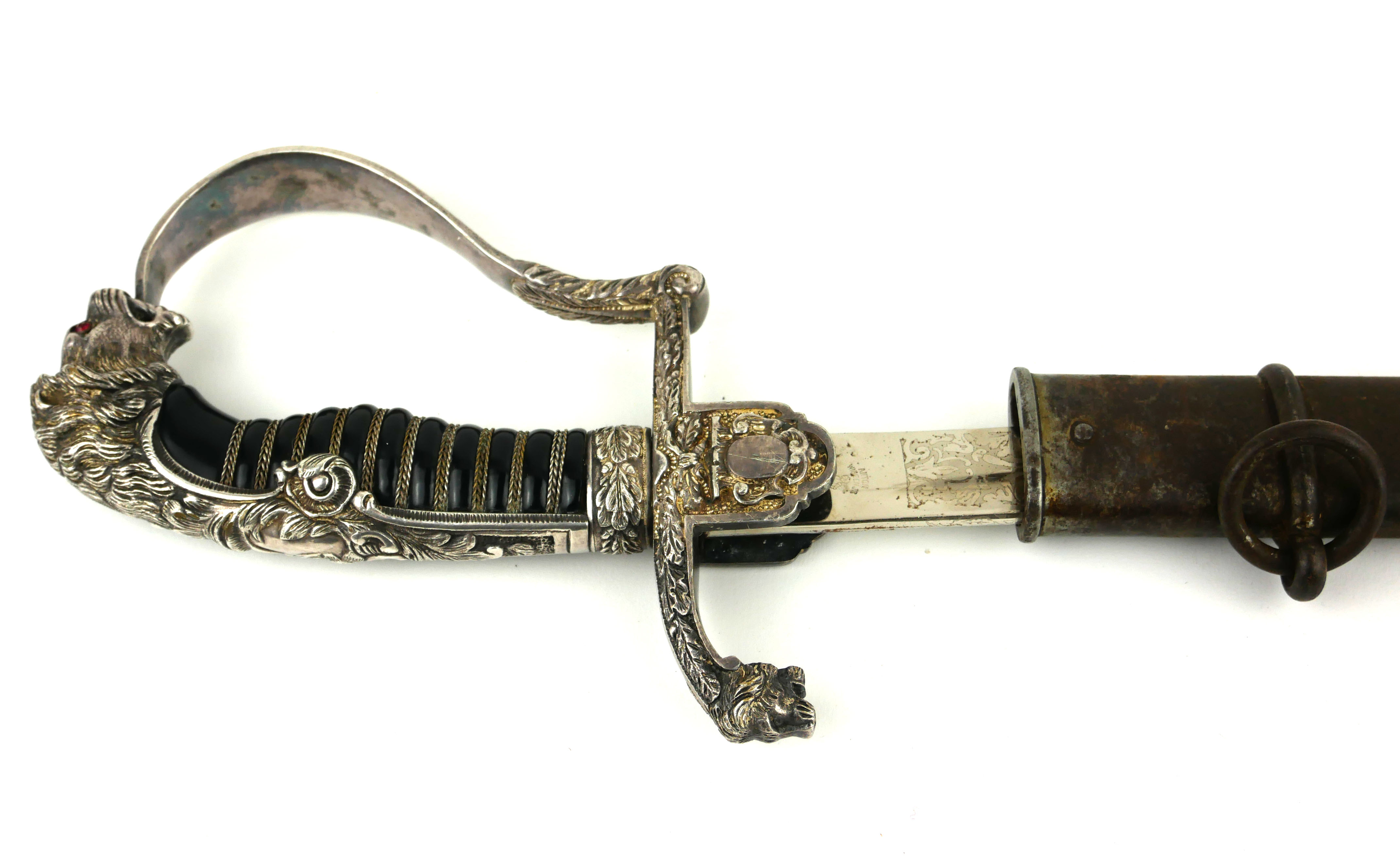 AN EARLY 20TH CENTURY GERMAN ARMY OFFICERS DRESS SWORD Having a lion mask handle and steel blade
