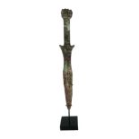 A CHINESE BRONZE DAGGER Cast with a mythical beast with fruit to handle, on black perspex stand. (