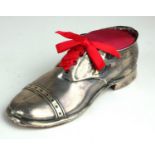 AN ENGLISH HALLMARKED SILVER PIN CUSHION FORMED AS A SHOE With wooden sole. (w 12.5cm)