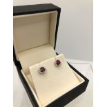 A PAIR OF 18CT WHITE GOLD, ROUND CUT RUBY AND DIAMOND EARRINGS. (ruby approx 0.84ct, diamond