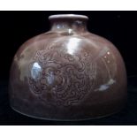 A CHINESE SQUAT BOTTLE VASE With scrolled design on purple glaze, bearing a six character Chinese