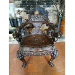 A 19TH CENTURY CHINESE DRAGON ARMCHAIR With carved back panels and seat, on cabriole legs with