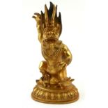 A CHINESE GILT BRONZE STATUE OF A MYTHOLOGICAL BEAST Having one arm, raised and sat with a sow