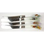 A SET OF FOUR EDWARDIAN WORCESTER PORCELAIN BUTTER KNIVES Pistol grip firm, each hand painted with