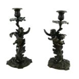 A PAIR OF 19TH CENTURY BRONZE CANDLESTICKS Figured with cherubs and acanthus leaves. (31cm)