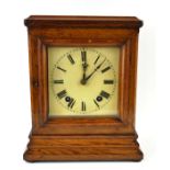 AN EDWARDIAN OAK MANTLE CLOCK Square cream dial with Roman number markings and striking mechanism,