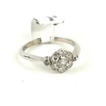 AN 18CT WHITE GOLD, PLATINUM AND OLD BRILLIANT CUT DIAMOND DAISY CLUSTER RING (size I). (2.2g)