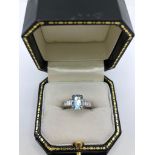 A PLATINUM, EMERALD CUT AQUAMARINE AND BAGUETTE CUT DIAMOND RING. (aquamarine approx 2.15ct)