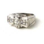 AN HEAVY ART DECO PLATINUM RING SET WITH A ROUND BRILLIANT CUT DIAMOND, on diamond encrusted