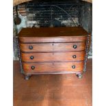 A 19TH CENTURY MAHOGANY BOW FRONTED CHEST OF THREE LONG DRAWERS Flanked by bobbin turned columns,