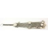 AN UNUSUAL CHINESE WHITE METAL ORNAMENTAL TASSEL CHAIN With circular finger holder, set with white