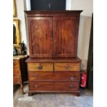 A 19TH CENTURY MAHOGANY CABINET ON CHEST With two cupboards enclosing shelves, above two short