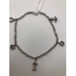 A 14CT WHITE GOLD CHARM BRACELET WITH DIAMOND CHARMS.