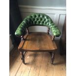 A VICTORIAN OAK CAPTAIN'S CHAIR With green leather button back upholstery on Bali twist supports