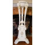 A LARGE CLASSICAL STYLE WOODEN TORCHERE Later white painted and gilt highlighted finish carved