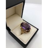 A VINTAGE 9CT GOLD AND LATER AMETHYST RING, CIRCA 1960 (size L).