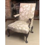 AN 18TH CENTURY WALNUT OPEN ARMCHAIR Upholstered in a floral fabric on oatmeal ground, raised on