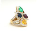 AN 18CT GOLD, DIAMOND AND GEM SET CLUSTER RING Having an arrangement of four pear cut stones, a