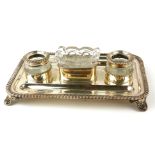 AN EARLY 20TH CENTURY SILVER PLATED INKSTAND With two glass bottles and central bowl and gadrooned