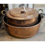 A LARGE VICTORIAN COPPER COOKING OVAL PAN AND COVER With twin handles and tin lined interior. (