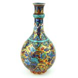 A KANGXI PERIOD BOTTLE VASE Profusely decorated with flowers on a gilt ground, marked, bearing a